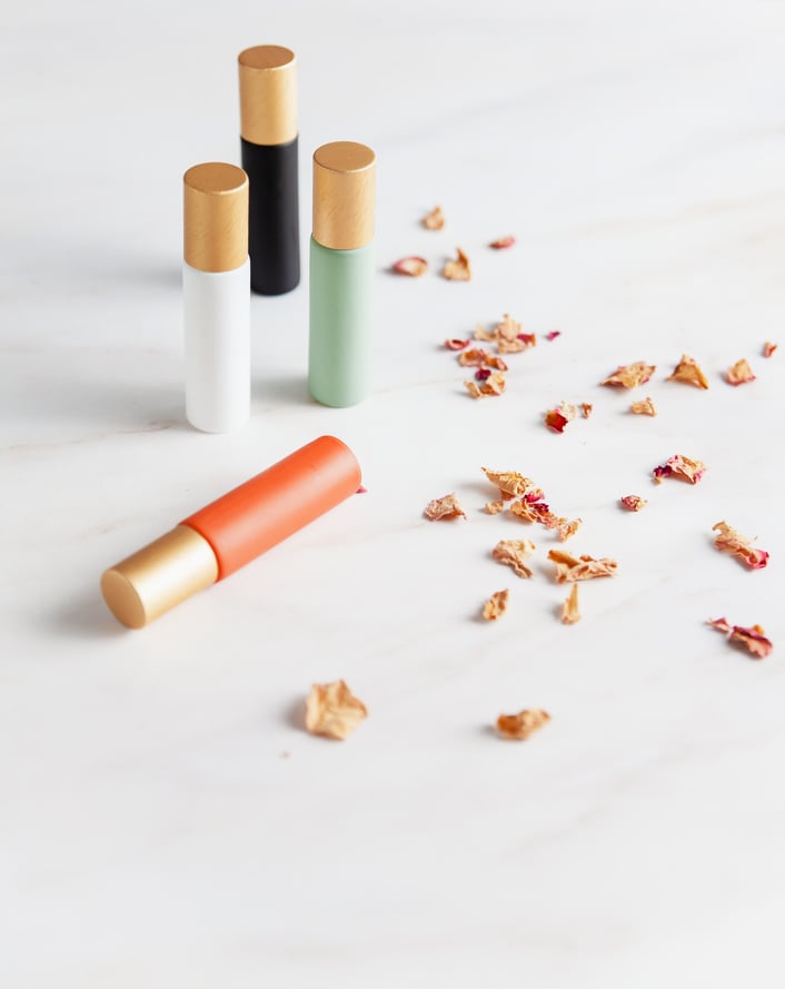 Natural roller ball perfumes in colorful containers