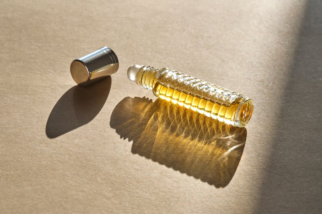 Oil roller perfume on a beige background.